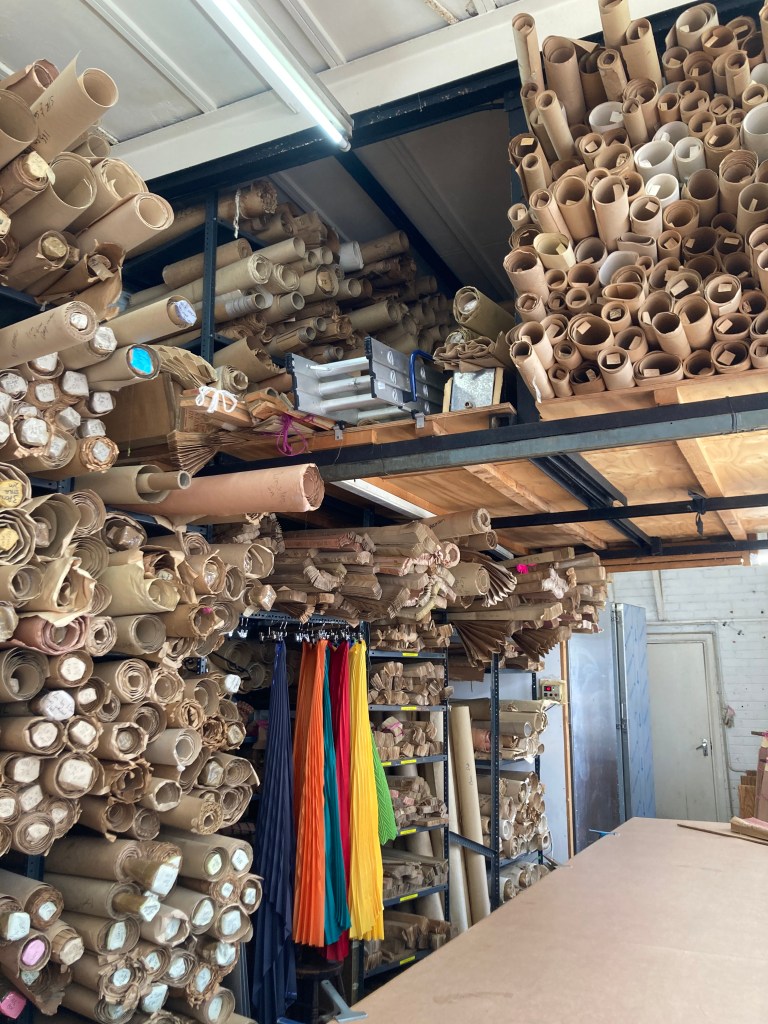 Wall full of pleating molds in the work studio.
